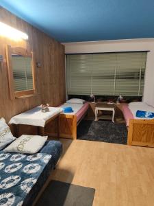 a room with three beds and a window at Lakeside Interlaken Jungfrau in Därligen