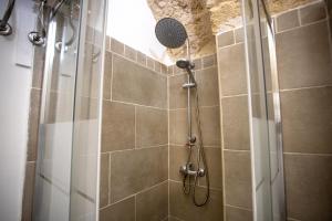 a shower with a shower head in a bathroom at Palazzo '800 Cementine in Leverano +68 photos