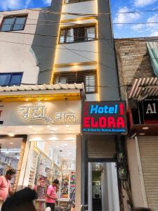 a store with a hotel eloro sign in front of a building at Elora Hotel in Ujjain