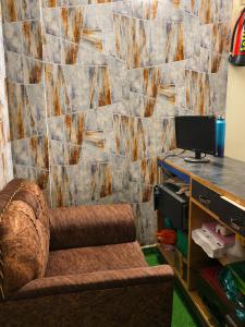 a room with a chair and a desk with a computer at Elora Hotel in Ujjain
