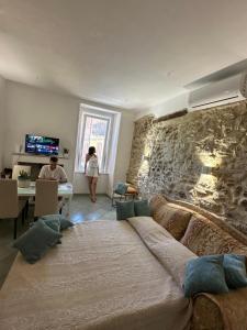 a bedroom with a large bed and a stone wall at B&B Don Nicola in Bonefro