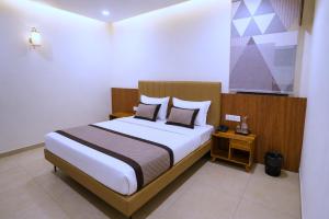 a bedroom with a large bed with white sheets at Raahi Home Stay Near Iskcon temple & Pushpa Mission Hospital in Ujjain
