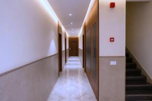 a hallway with stairs and elevators in a building at Raahi Home Stay Near Iskcon temple & Pushpa Mission Hospital in Ujjain