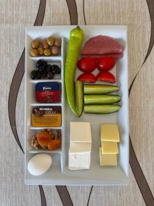 a tray of food with cheese vegetables and meats at Doğa Villa Guest House in Büyükçekmece