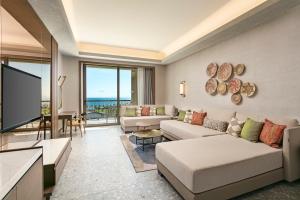 a living room with a couch and a flat screen tv at Cullinan Belek in Belek