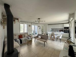 a living room with a couch and a stove at Emmanuel INN 3 in Drancy