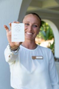 a woman is holding up a piece of paper at Vigna Caio Relais & Spa in Bracciano +94 photos