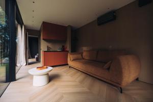 a living room with a couch and a table at Stars Resort Sigulda in Sigulda