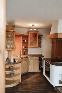a kitchen with wooden cabinets and a sink at Center Chalet in Mayrhofen