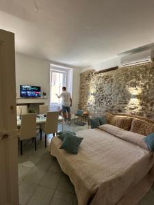 a man is standing in a room with a bed at B&B Don Nicola in Bonefro