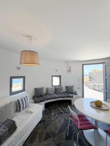 a living room with a couch and a table at Anemos Mill House in Imerovigli