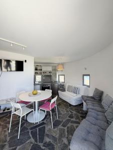 a living room with a couch and a table at Anemos Mill House in Imerovigli
