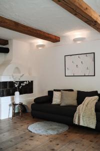 a living room with a black couch and a table at Center Chalet in Mayrhofen