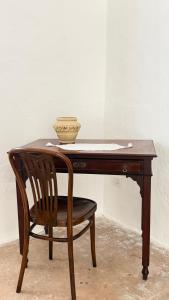 a wooden desk with a chair and a bowl on it at B&B Vernole1713 in Vernole +20 photos
