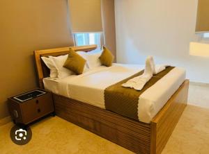 a bedroom with a large bed with a wooden frame at Alwar stay in Alwar