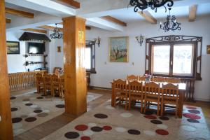 a dining room with a table and chairs at Pension Sf Nicolae in Aluniş