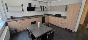 a kitchen with a table and chairs in a room at LionEstateHostel in Liepāja
