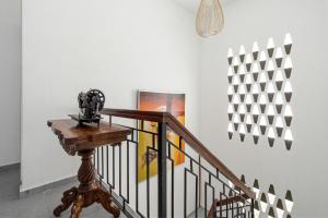 a camera on a stand next to a staircase at Ruum1 Sugars Houz in Johor Bahru +1 photo