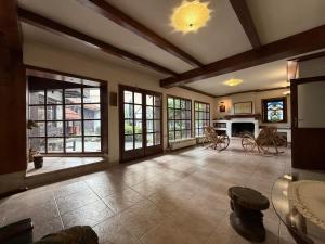 a large living room with windows and a fireplace at White Wolf Chalet in Bansko