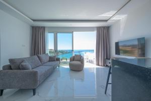 a living room with a couch and a television at Atlantis Malibu by Carrington in Kyrenia