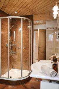 a bathroom with a shower and a tub at Center Chalet in Mayrhofen +52 photos