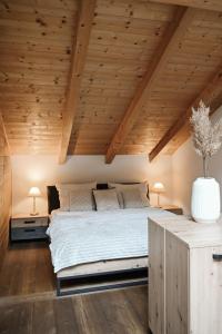 a bedroom with a large bed and wooden ceilings at Center Chalet in Mayrhofen