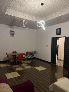 a room with a table and chairs and a ceiling at Furyan Lodge in Cape Coast +2 photos