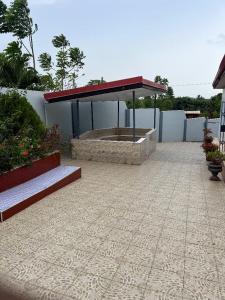 a pavilion with a fountain in the middle of a patio at Furyan Lodge in Cape Coast