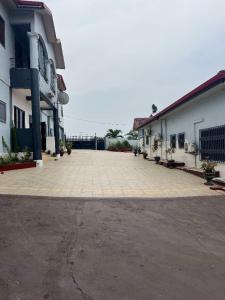 an empty parking lot in front of a building at Furyan Lodge in Cape Coast