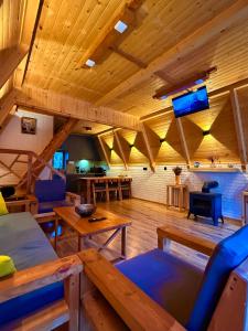 a living room with wooden ceilings and wooden tables at La Seasons in Hors