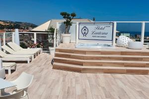 a sign for a third anniversary event on a patio at Hotel Lanterna in Porto San Giorgio