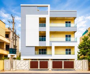a white building with a fence in front of it at Maruthi inn hotel in Vijayawāda