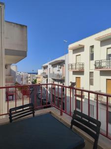 a balcony with two benches and a yoga mat on it at I colori di Otranto by CASASI Vacanze Otranto in Otranto