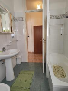 a bathroom with a sink and a tub and a toilet at I colori di Otranto by CASASI Vacanze Otranto in Otranto +33 photos