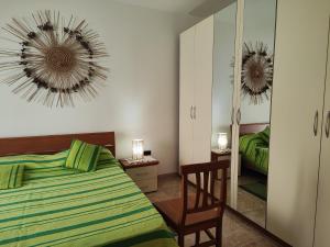 a bedroom with a bed and a mirror at I colori di Otranto by CASASI Vacanze Otranto in Otranto