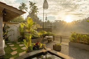 a balcony with a garden with the sun setting at Legong Sebatu Villa in Ubud +122 photos