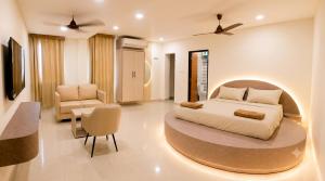 a bedroom with a bed and a table and chairs at Maruthi inn hotel in Vijayawāda