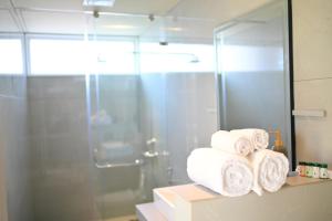 a pile of towels on a shelf in a bathroom at Mavi Retreat in Badami