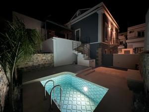 a house with a swimming pool at night at ARCHONTIKO Atsas - Amethystos in Kalymnos