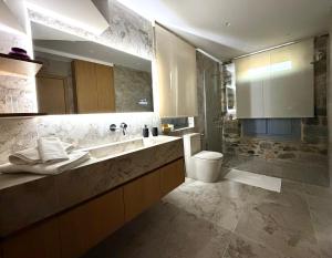 a bathroom with a sink and a toilet and a shower at ARCHONTIKO Atsas - Amethystos in Kalymnos +8 photos