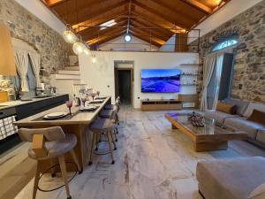 a large living room with a couch and a table at ARCHONTIKO Atsas - Amethystos in Kalymnos