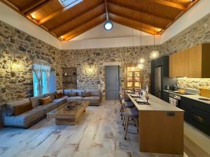 a kitchen and living room with a couch and a table at ARCHONTIKO Atsas - Amethystos in Kalymnos