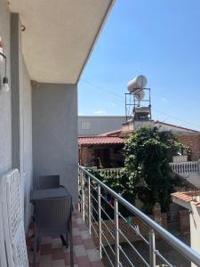 a balcony with a table and a water tank on a building at Hotel Luis in Durrës