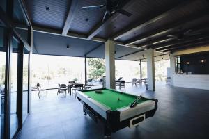 a pool table in the middle of a room at Riverawan Hotel in Chanthaburi