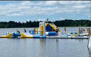 a group of people in the water on a water slide at Zen Garden House in Võduvere