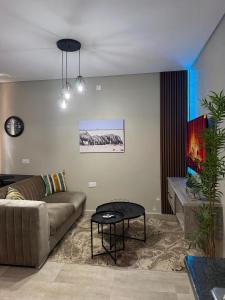 a living room with a couch and a table at No75 Stays in Tlokweng