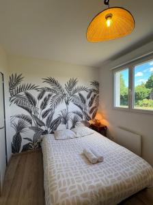 a bedroom with a bed with a large plant wall at Maison Pro Le Blanc - 3 chambres plus un canapé lit in Le Blanc