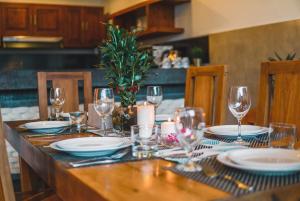 a table with plates and wine glasses on it at Lapiz Lazuli in Seminyak