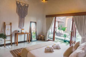 a bedroom with a bed and a large window at Lapiz Lazuli in Seminyak +76 photos