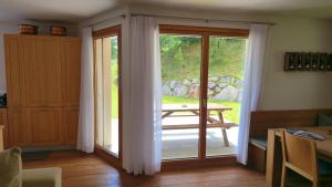 a sliding glass door leading to a patio at Splendida e soliva dimora con giardino in La Punt-Chamues-ch +7 photos